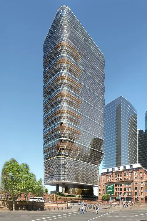 Modernes Hochhaus mit einer Glasfassade und mehreren etagenweisen Terrassen, Menschen laufen auf dem Gehweg davor, blauer Himmel im Hintergrund.